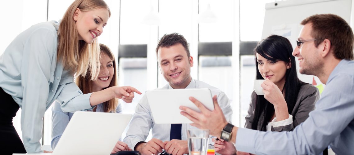 Group of business people working with digital tablet in office